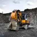 yellow and black excavator near hill