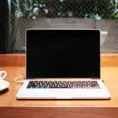 laptop computer beside coffee mug